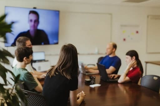 Transformation des organisations : équipe de jeunes collaborateurs en réunion de travail par vidéoconférence dans une entreprise en mode de management agile.